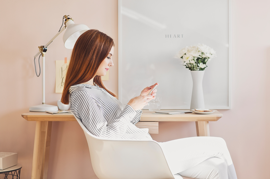 Businesswoman Typing on Her Cell Phone